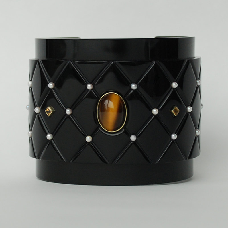 For sale Faberges secret wide cuff bracelet From Russia with love collection quilted effect black plexiglass 14K yellow gold tigers eye pearl citrine amethyst unique piece € 1545,- Daphne Meesters Jewellery Designer Goldsmith The Hague Netherlands