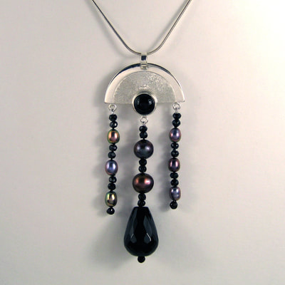 Art deco multi-jewel chandelier pendant 79 millimetres ear jackets 93 millimetres sterling silver arch with cabochon onyx dangling multi colour pearls faceted drop onyx unique piece € 245,- Daphne Meesters Jewellery Designer Goldsmith The Hague Netherlands