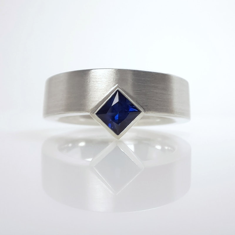 Fair and square ring  sterling silver modern wide band with matte finish and stunning dark blue sapphire princess cut square Daphne Meesters Jewellery Designer Goldsmith The Hague Netherlands