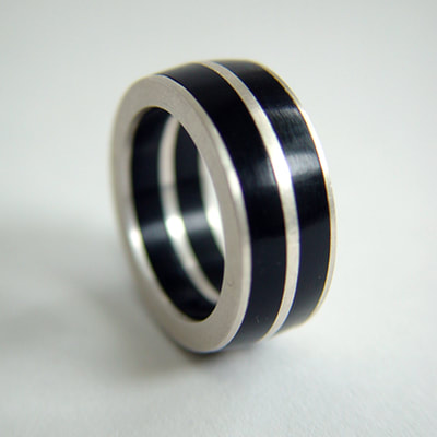 Ring unisex sterling silver and black plexiglass lines Daphne Meesters Jewellery Designer Goldsmith The Hague Netherlands
