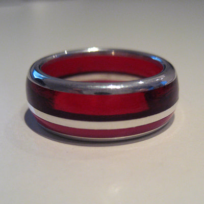 Red ring sterling silver red and pink plexiglass lines semi rounded size 17 millimeters € 195,- Daphne Meesters Jewellery Designer Goldsmith The Hague Netherlands
